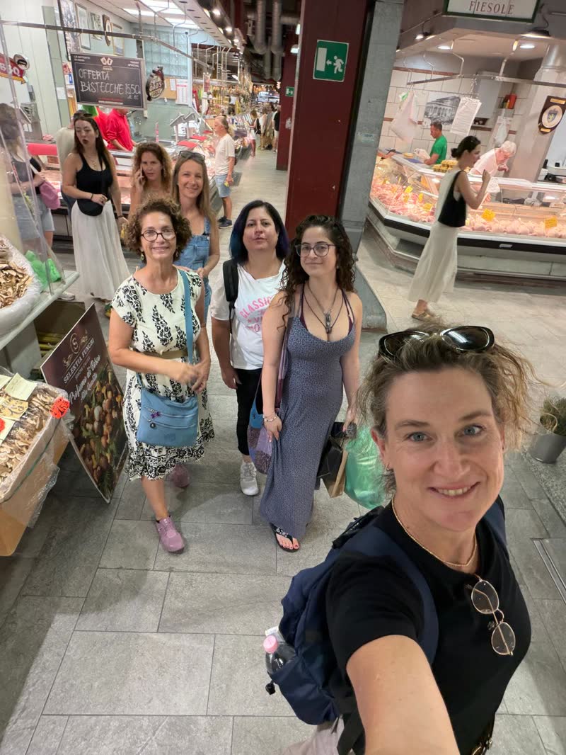 Shira Brand and the group in a covered market in Florence